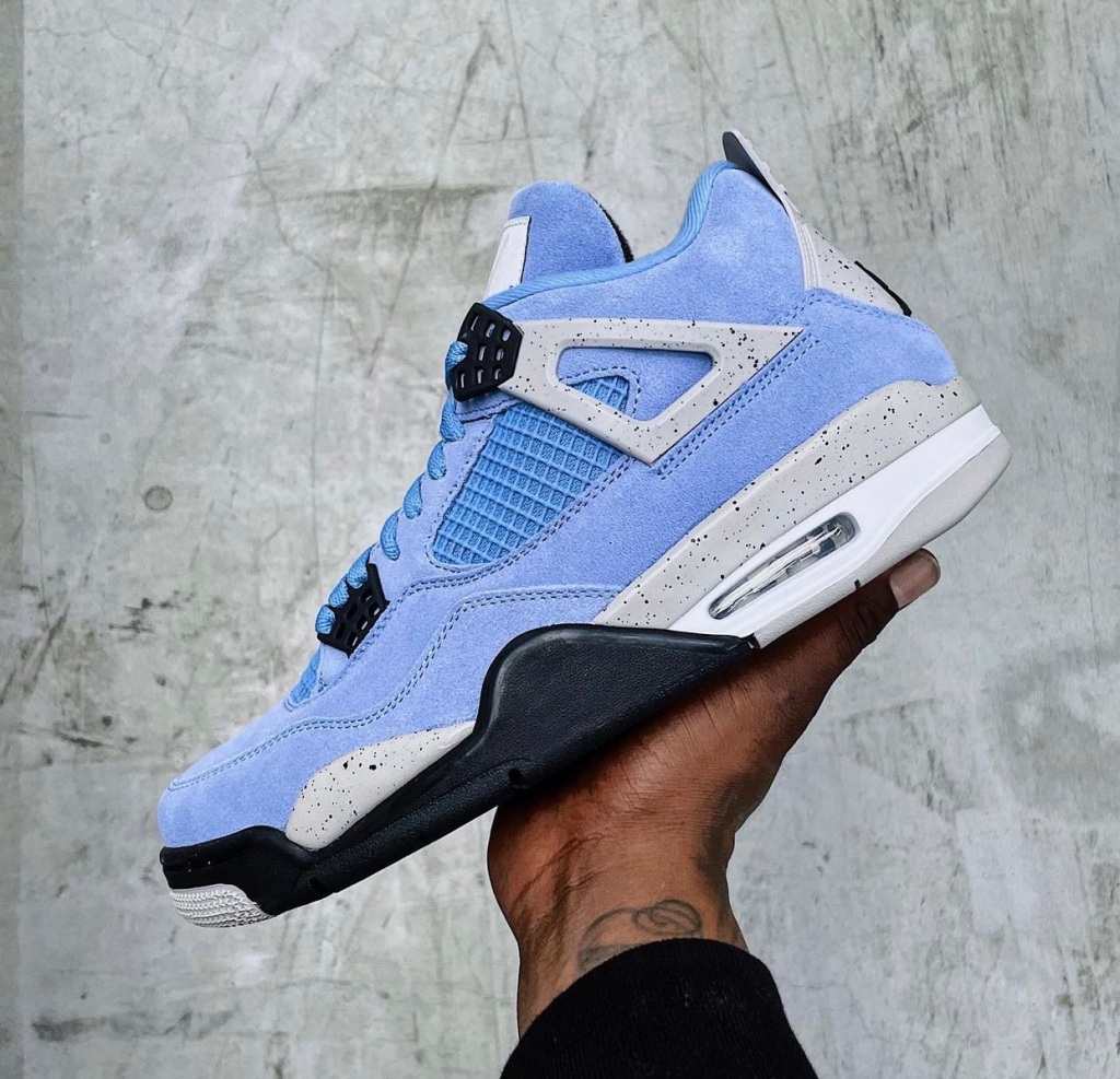 Air Jordan 4 University Blue, blue upper with speckled grey accents and a white midsole.